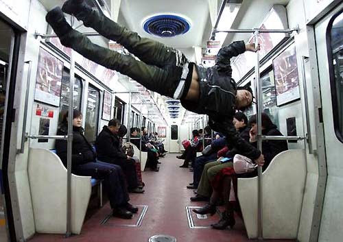 Du Yize, a young Chinese parkour fan, practices in a subway carriage in Beijing. [Photo: China Photo Press]