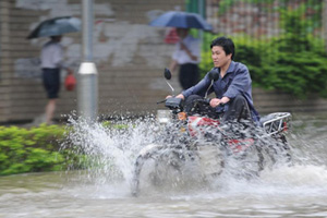 Road destroyed by rain-triggered floods in S China