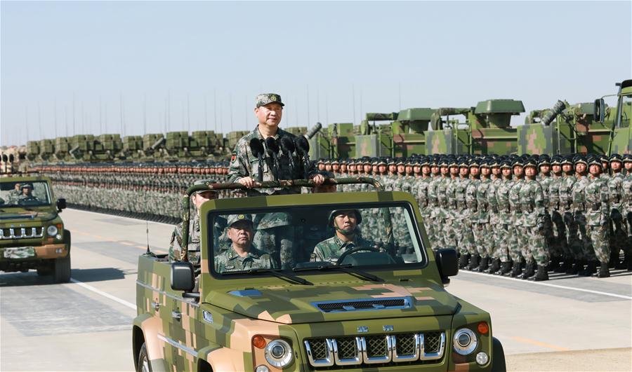 Xi reviews parade in field for first time
