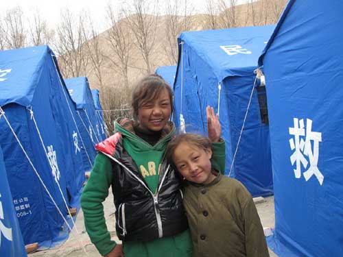Children grimace, smile in quake zone