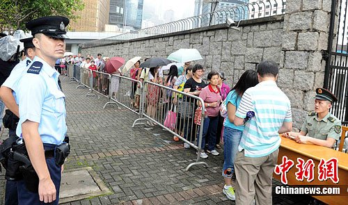 香港市民冒雨領(lǐng)取“愛(ài)在香港”慶回歸15周年晚會(huì)門(mén)票