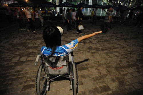 Wheelchair volunteer guides spectators