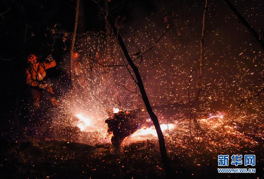 Firefighters battle Beidahe forest inferno
