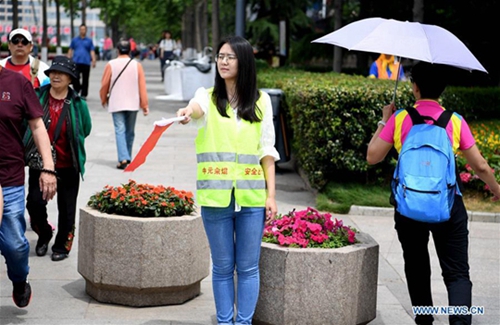 Volunteers seen on street in host city of 18th SCO Qingdao Summit