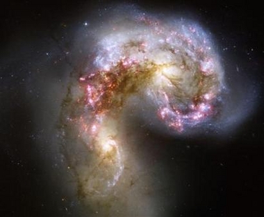 This Hubble image of the Antennae galaxies is the sharpest yet of this merging pair of galaxies. As the two galaxies smash together, billions of stars are born, mostly in groups and clusters of stars. The brightest and most compact of these are called super star clusters
