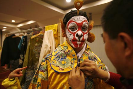Ghaffar Pourazar of Britain gets dressed before performing in an English version of the traditional Chinese opera Monkey King at a theatre in Shanghai December 8, 2006. Pourazar is the first foreigner to complete the rigorous training at the Beijing Opera School and the National Academy. He is performing with Chinese artists from the International Centre for Beijing Opera, and other troupes, at their first show in Shanghai. 