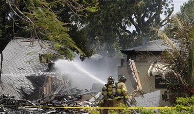 Plane splits home in half, pilot dies