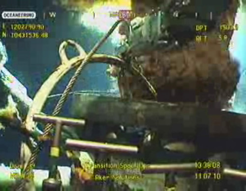 BP's new oil cap headed for well, then testing